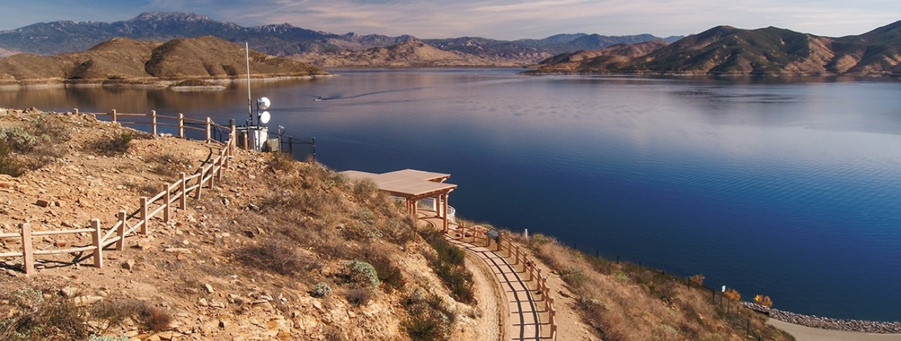 A photo of a city skyline above the clouds with the OurCounty logo overlayed on top 